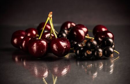 fresh cherry and black currant over a dark grey backgroundの写真素材