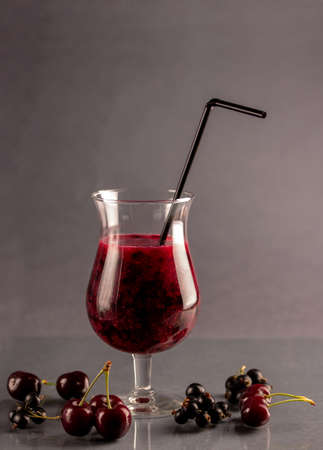Fresh black currant and cherry mixed smoothie in glassの写真素材