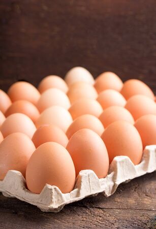 close up of hen eggs over wooden tableの写真素材