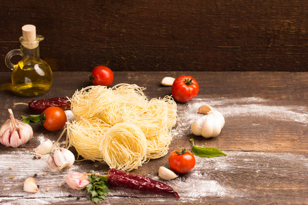 italian egg pasta with food  ingredients over rustic backgroundの写真素材