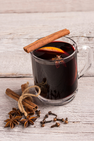 a glass of mulled wine with spices and orangeの写真素材