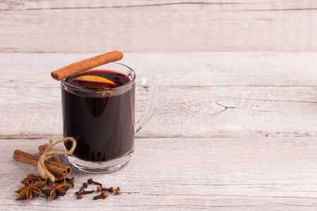 Mulled wine in glass with cinnamon stick and aniseの写真素材