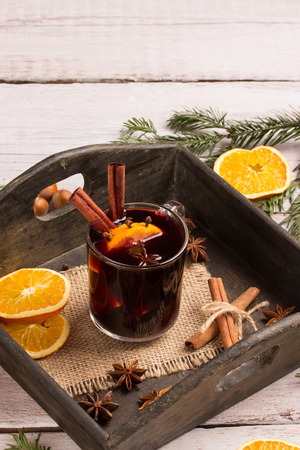 a glass of mulled wine with spices and orangeの写真素材
