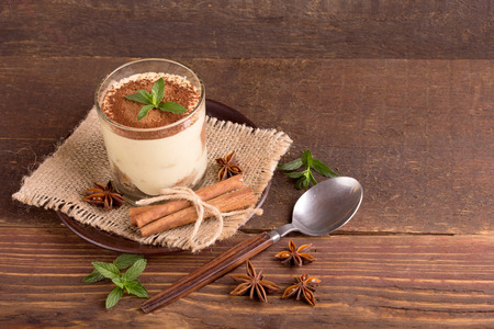 Tiramisu in the glass on the wooden backgroundの写真素材