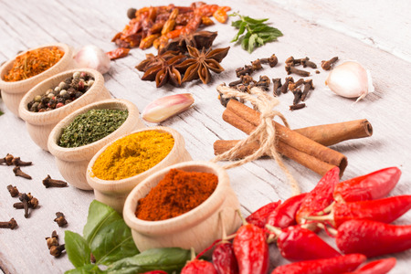 colorful spices on a white wooden table in a rustic styleの写真素材
