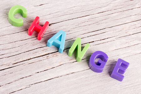 the word change written on a white wooden backgroundの写真素材