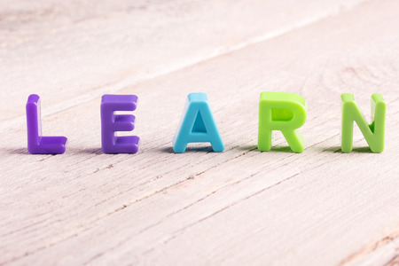 the word learn written on white wooden surfaceの写真素材