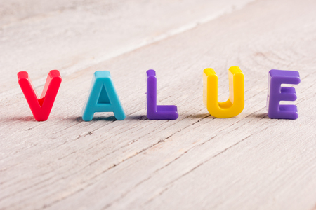 the word value on a white wooden surfaceの写真素材