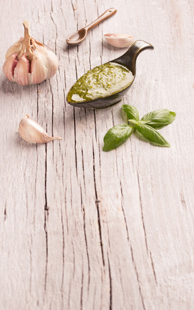 Pesto Genovese in a gravy boat and basilの写真素材