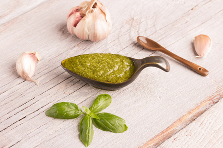 basil pesto in ceramic bowl on kitchen tableの写真素材