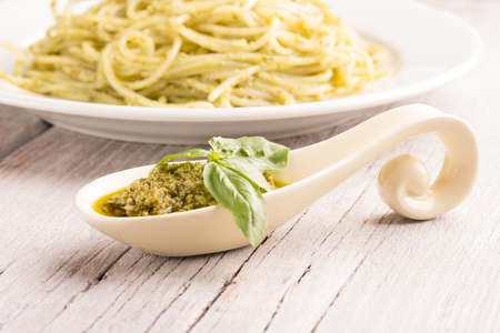 pesto sauce with spaghetti with pesto in the backgroundの写真素材