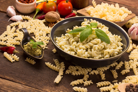 italian fusilli pasta with homemade pesto sauce in rustic styleの写真素材