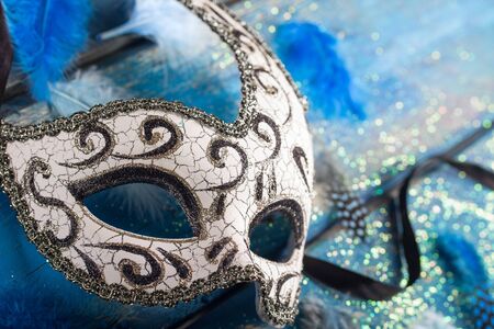 female carnival mask with blue glittering backgroundの写真素材