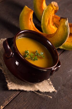 Pumpkin soup in rustic bowlの写真素材