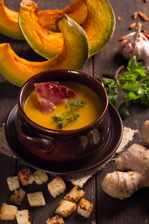 traditional pumpkin soup on wooden tableの写真素材
