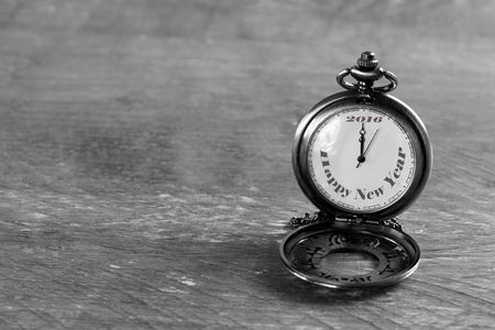 a pocket watch on a rustic table with the text " Happy New Year 2016''の写真素材