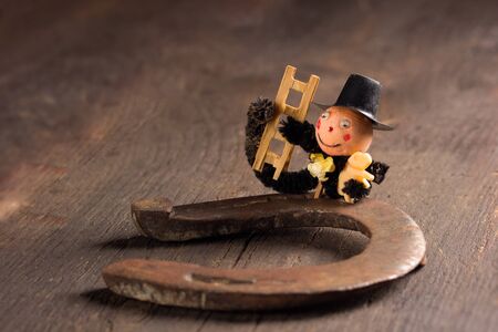 Horseshoe and chimney sweep on wooden table,good luckの写真素材