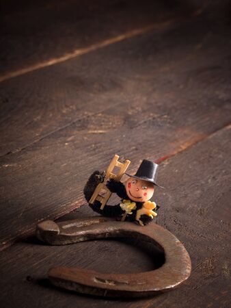 Horseshoe and chimney sweep on wooden table,good luckの写真素材