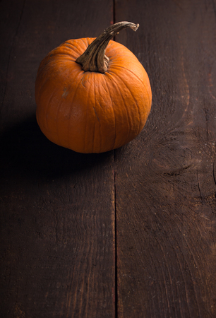 one single pumpkin over wooden backgroundの写真素材