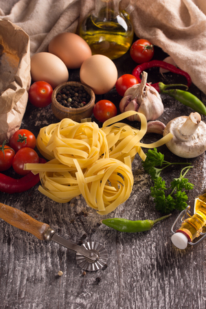vertical composition of nest pasta with vegetables,herbs and spicesの写真素材