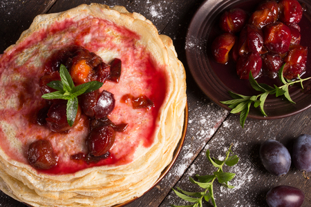 top view of delicious pancakes with homemade fresh plum`s confitureの写真素材
