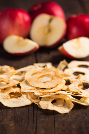 dried apple with fresh red apples in the backgroundの写真素材