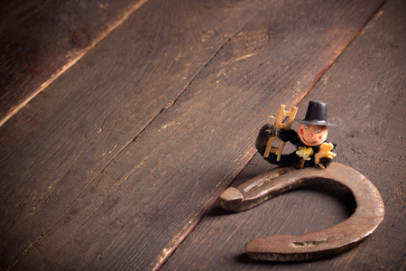 Horseshoe and chimney sweep on wooden table,good luckの写真素材