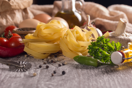 dry pasta tagliatelle with tomatoes, herb and spicesの写真素材