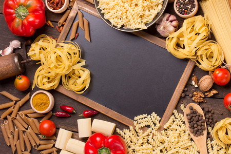 Different types of pasta and a chalkboardの写真素材