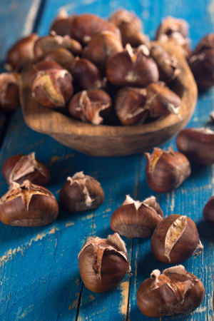 roasted chestnut on blue wooden tableの写真素材