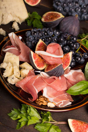 appetizer with ham, grapes and figの写真素材