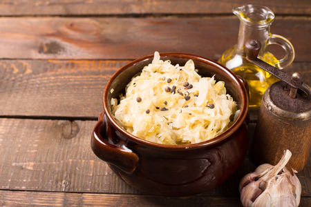 sour cabbage on a rustic dark wooden tableの写真素材