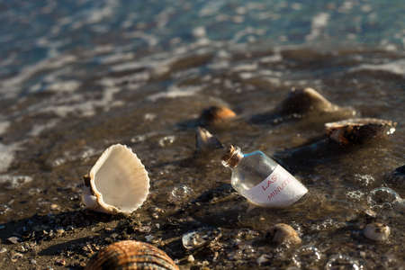 last minute message in a bottle on beautiful beachの写真素材