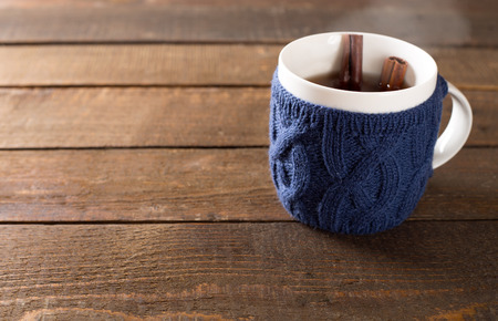 mulled wine in a cute cup over wooden backgroundの写真素材