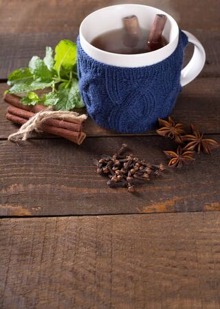 Cup of hot drink with knitted thing on.の写真素材