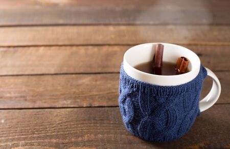 Mulled wine in a cute cup over wooden backgroundの写真素材