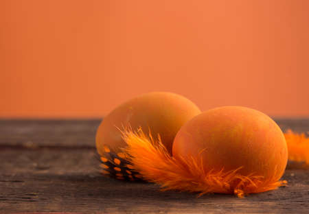 beautiful orange easter eggs on wooden backgroundの写真素材