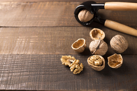 walnuts with nutcracker on a rustic tableの写真素材