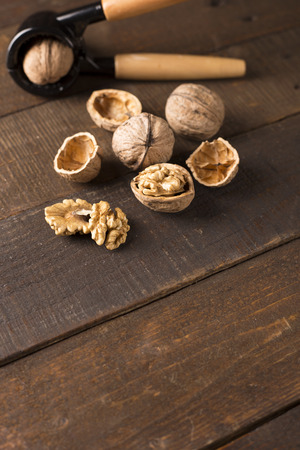 walnuts with nutcracker on a rustic tableの写真素材