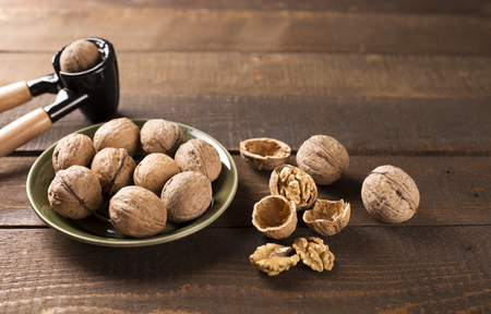 walnuts with nutcracker on a green plateの写真素材
