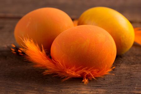 beautiful orange easter eggs on wooden backgroundの写真素材