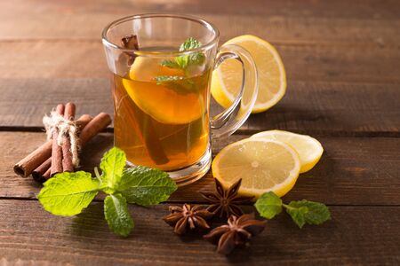 Cup of tea and mint on a wooden backgroundの写真素材