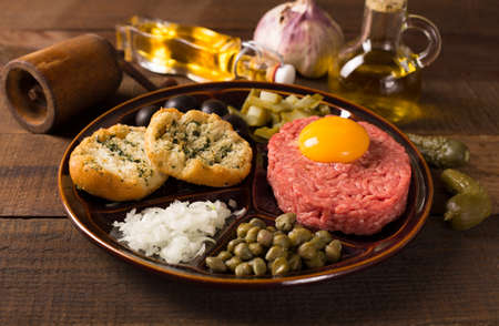 fresh beef tartar with egg, onion, capers, cucumberの写真素材