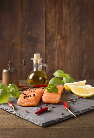 Delicious portion of fresh salmon fillet with aromatic herbs, spicesの写真素材