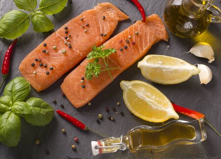 Delicious portion of fresh salmon fillet with aromatic herbs, spicesの写真素材