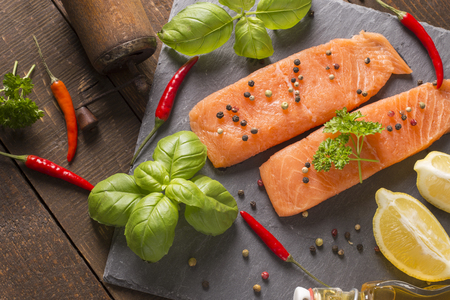 raw salmon filet on a stone boardの写真素材