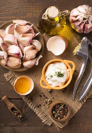 Portion of homemade Aioli dip in small bowl on wooden backgroundの写真素材