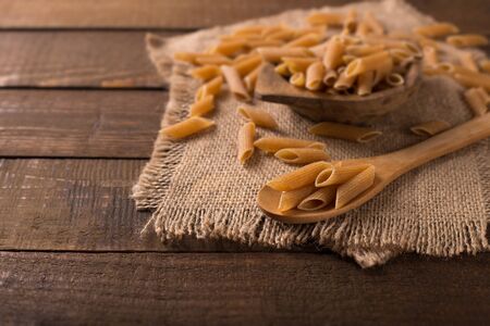 Bowl of penne noodles in rustic styleの写真素材
