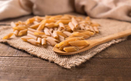 Bowl of penne noodles in rustic styleの写真素材