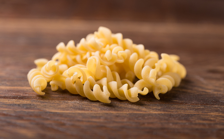 fusilli pasta on rustic  wooden backgroundの写真素材